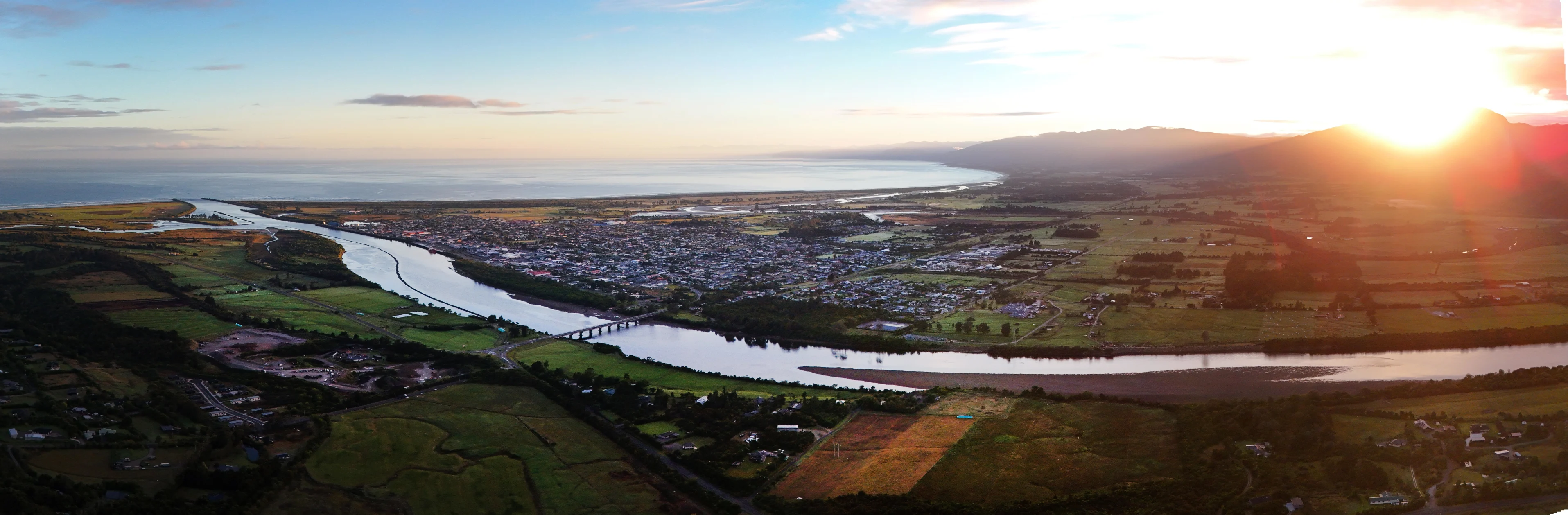 Extreme wide angle aerial shot of river mouth at dawn
