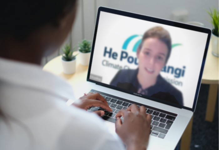 Person watching a Commission webinar on a laptop.